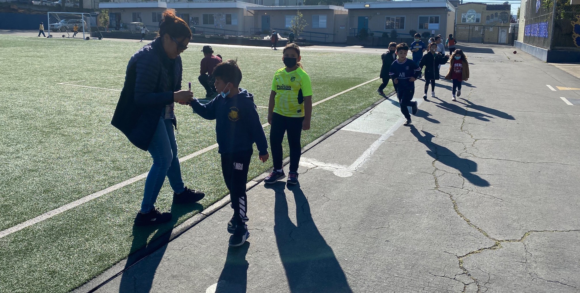 Child having hand marked while walking
